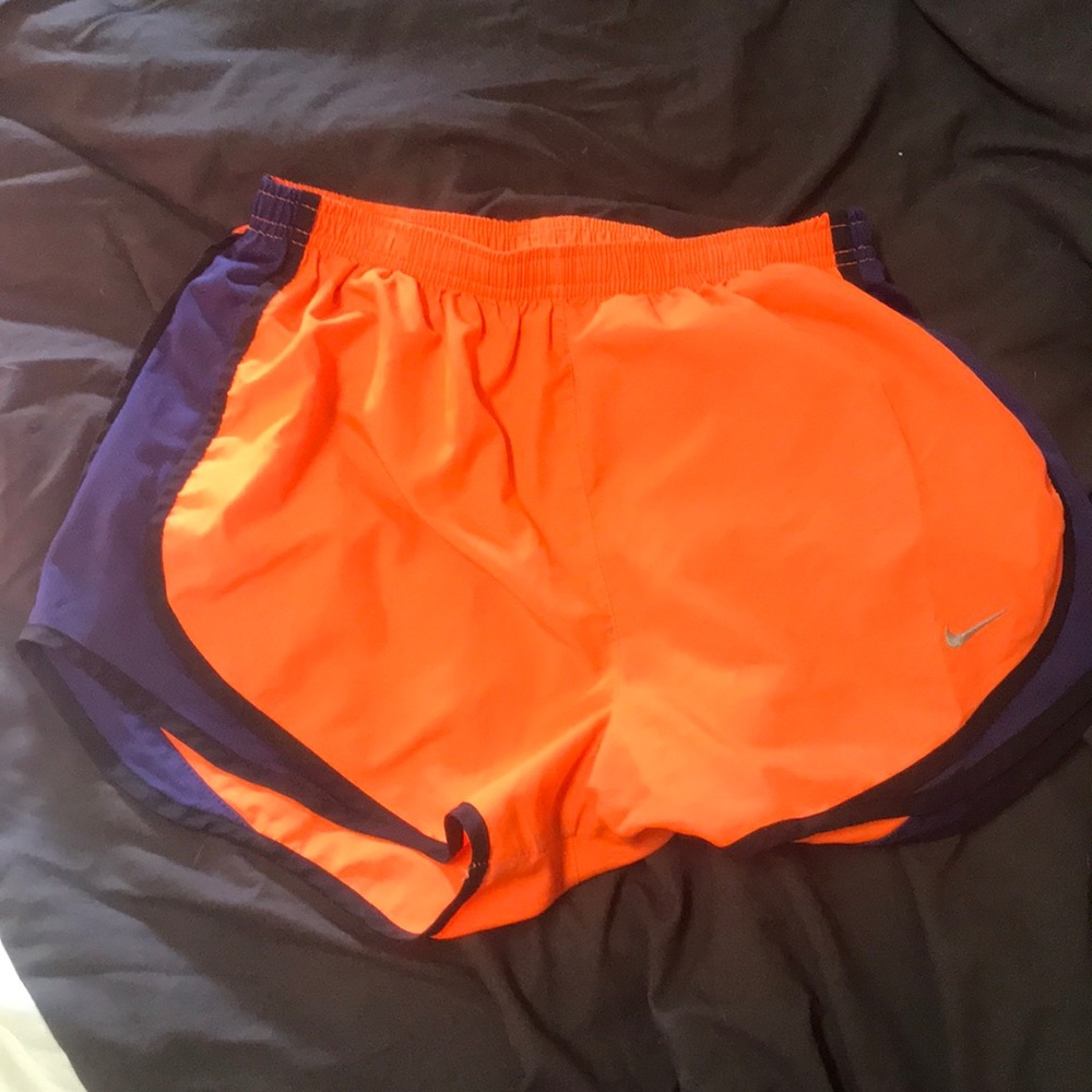 Neon orange and purple Nike running shorts